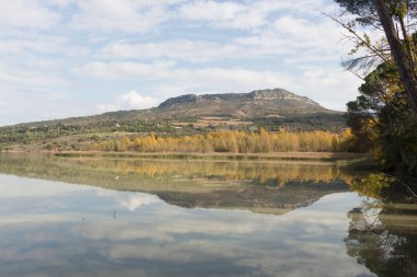Reflections in the lake in autumn with clouds