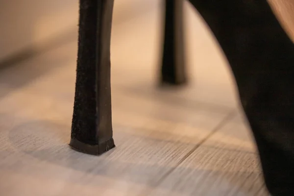 A close up of a women\'s shoe, black suede pumps.