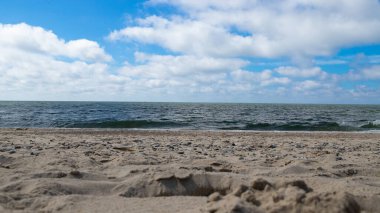 Close-up of the sand on a beach with the sea in the background. High quality photo