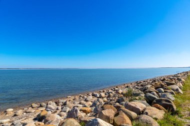 Rocky beach by the sea in Denmark with blue sky. High quality photo