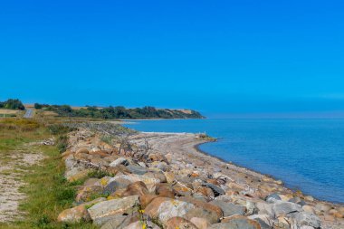 Rocky beach by the sea in Denmark with blue sky. High quality photo