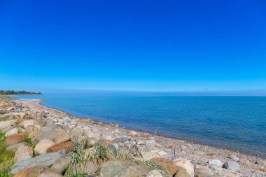 Rocky beach by the sea in Denmark with blue sky. High quality photo