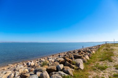 Rocky beach by the sea in Denmark with blue sky. High quality photo