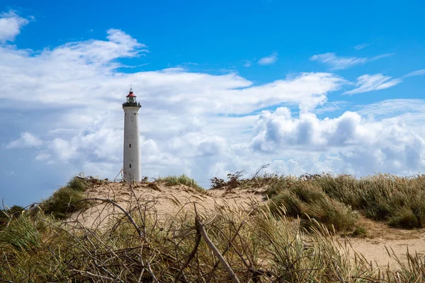 stock image Lighthouse behind a dune and blue sky. Lyngvig Fyr in denmark High quality photo