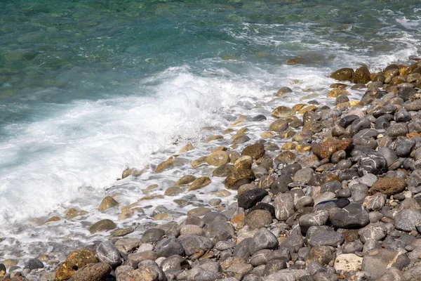 Sea coast in Crete with stones in the sea and waves. High quality photo