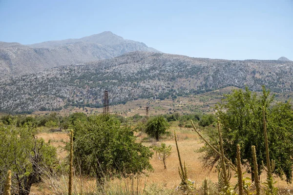 stock image Panorama of a rough rock landscape in Crete with mountains in the background. High quality photo