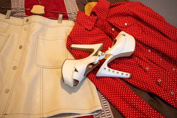Clothing White Leather Skirt, Red Blouse, Very High White Wedge Heel Shoes. High quality photo
