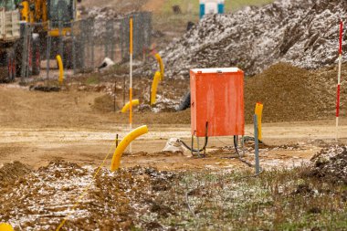 Construction electricity box on a road construction site with a little snow. High quality photo clipart