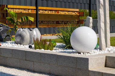 Mermer Taş Yataklı Granit Duvar, Beyaz Balo Lambası Çimenleri ve Mermer Çeşmeli. Yüksek kalite fotoğraf