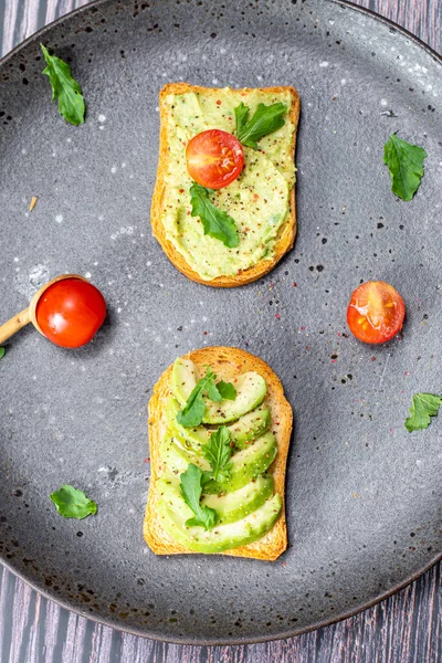 tasty breakfast of salmon toast with avocado and tomato