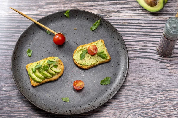tasty breakfast of salmon toast with avocado and tomato
