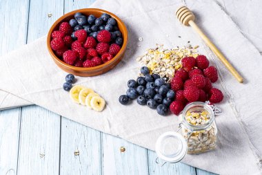 tasty meal with yoghurt, banana, berries and cereals