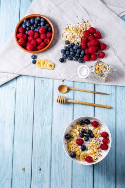 tasty meal with yoghurt, banana, berries and cereals