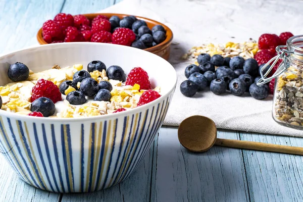 tasty meal with yoghurt, banana, berries and cereals