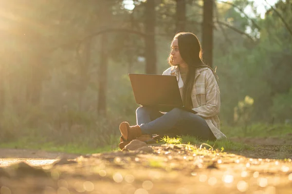 young girl relaxes walking through a beautiful forest at sunset
