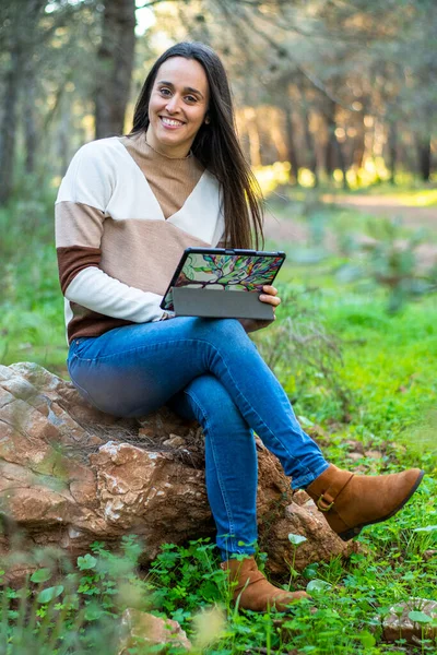 young girl relaxes walking through a beautiful forest at sunset