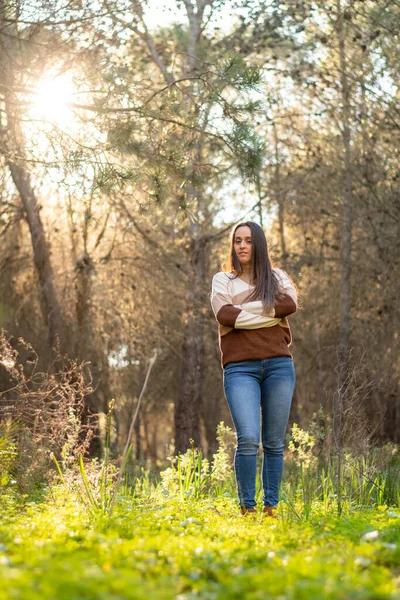young girl relaxes walking through a beautiful forest at sunset