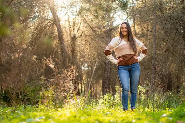 young girl relaxes walking through a beautiful forest at sunset