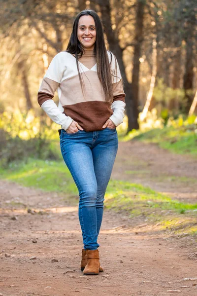 young girl relaxes walking through a beautiful forest at sunset