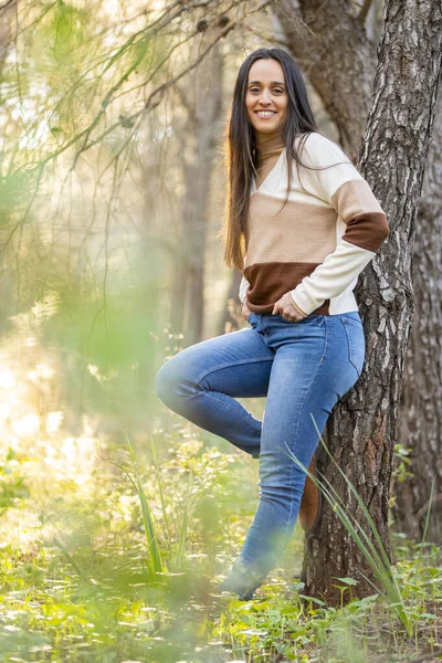 young girl relaxes walking through a beautiful forest at sunset