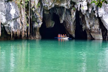 Palawan, Philippines - tourists on the boats visiting Puerto Princesa subterranean underground river clipart