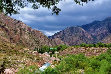 River and orange rocky mountains. The Mendoza River is a river in the province of Mendoza, Argentina.