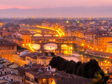 Ponte Vecchio gece altın ışıklarla ve Arno nehri ile