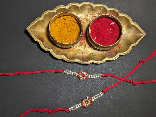 Raksha Bandhan, Indian festival with beautiful Rakhi in Black Background. A traditional Indian wrist band which is a symbol of love between Sisters and Brothers.