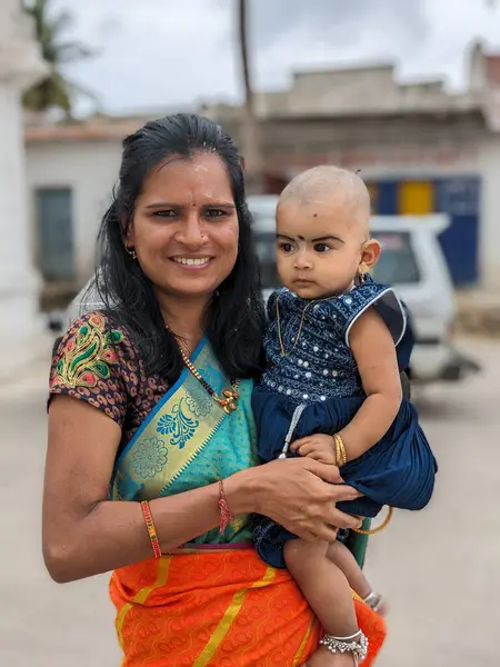 Anneler Günün kutlu olsun! Çocuk kızı annesini tebrik eder ve ona çiçek verir. Anne ve kız gülümsüyor ve sarılıyorlar. Aile tatili ve birliktelik.