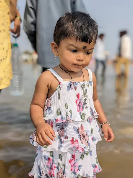 Bebek Kız nehir suyunda farklı bir ifadeyle oynuyor.