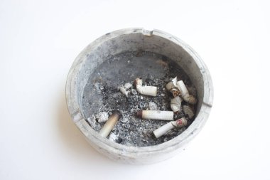 dirty ashtray full of cigarette butts isolated in white background