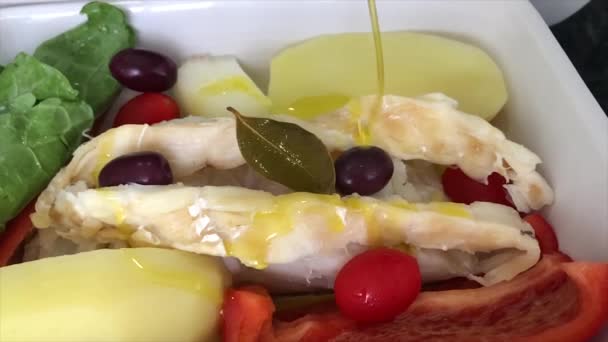 ビデオでジャガイモ 黒オリーブ キャベツとスライスで伝統的なポルトガルのコードフィッシュレシピ — ストック動画