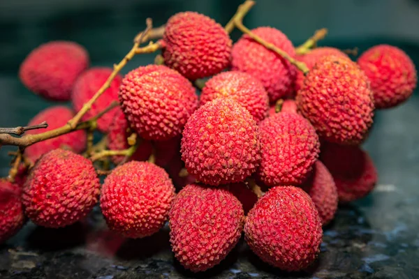 stock image Ripe lychee fruit (Litchi chinensis) isolated in dark background and selective focus