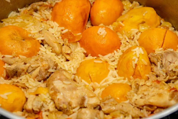 Traditional recipe for pequi (Caryocar Brasiliense) with rice and chicken in selective focus. Details