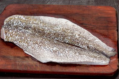 Sea fish fillet (Pseudopercis numida) isolated in selective focus. Known as boyfriend fish