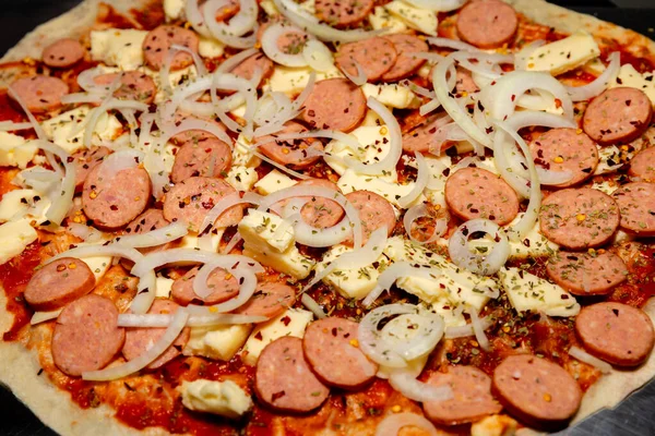 stock image Preparing pepperoni sausage pizza with onions