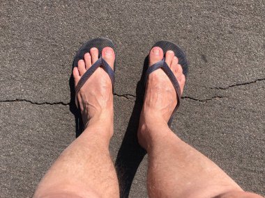 Çıplak ayaklar çimlere ve yere basıyor.