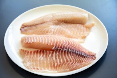 Tilapia filetosu ya da Aziz Peter balık Oreochromis niloticus. Beyaz arkaplanda izole