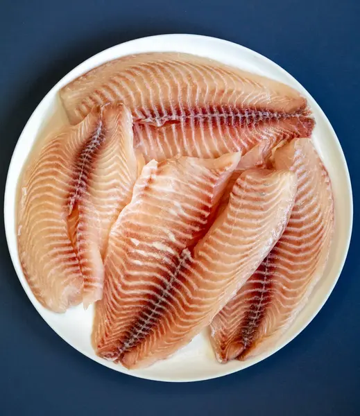 stock image Fillet of tilapia or Saint Peter fish Oreochromis niloticus. Isolated on white background