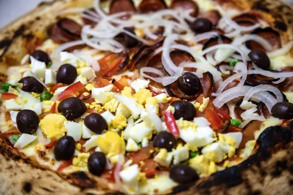 stock image Traditional Brazilian pizza, half pepperoni with onions and half Portuguese