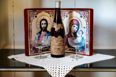  Old family heirlooms, very old Alba sparkling wine and Catholic religious icons clipart