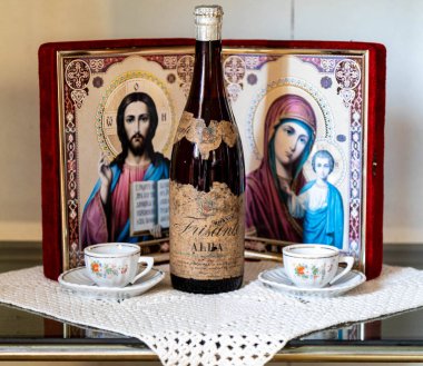  Old family heirlooms, very old Alba sparkling wine and Catholic religious icons clipart