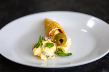 Geleneksel koni pipetleri mayonez, zeytin ve maydanozla dolu.