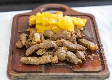 Traditional rustic tropical Brazilian dish, sun-dried beef with green beans, cassava, biquinho pepper. Creative rustic photography clipart