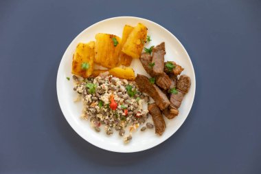 Traditional rustic tropical Brazilian dish, sun-dried beef with green beans, cassava, biquinho pepper. Creative rustic photography clipart