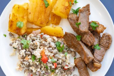 Geleneksel tropikal Brezilya yemeği, güneşte kurutulmuş yeşil fasulye, kasava, biquinho biberi. Yaratıcı kırsal fotoğrafçılık