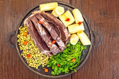 Traditional rustic tropical Brazilian dish, sun-dried beef with green beans, cassava, biquinho pepper. Creative rustic photography clipart