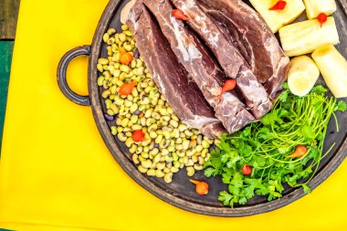 Traditional rustic tropical Brazilian dish, sun-dried beef with green beans, cassava, biquinho pepper. Creative rustic photography clipart