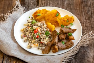 Traditional rustic tropical Brazilian dish, sun-dried beef with green beans, cassava, biquinho pepper. Creative rustic photography clipart