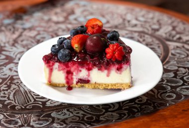 Yaratıcı ve lüks dekorasyonlu geleneksel kırmızı meyveli kek.